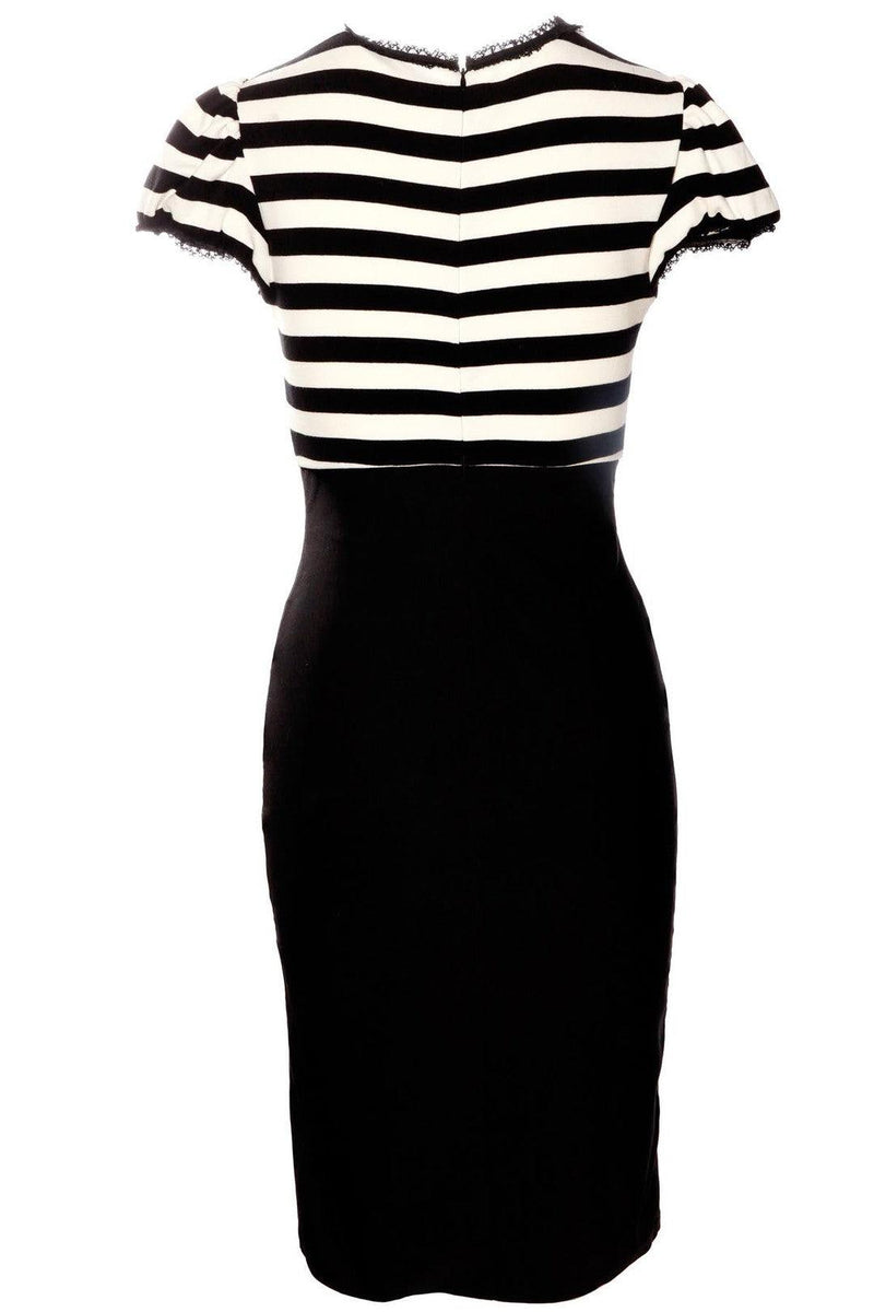 The Jessica Louise Molly Keyhole Dress is a chic, curve-enhancing dress that merges playful femininity with timeless retro influences. Crafted from high-quality stretch bengaline, the design showcases a flattering fitted silhouette, elevated waistline, and graceful ruffle details. Its puff sleeves and keyhole bust cutout offer a balance of modesty and allure, while the signature Heart Bow embellishment adds a hint of whimsy. Ideal for alternative fashion enthusiasts.