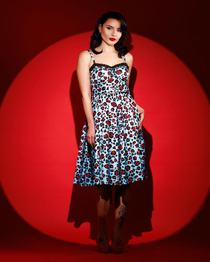 Jessica Louise Love Bites Swing Dress in custom Leopard Print featuring a sweetheart bustline with playful ruffled details and a ribbon bow accent, designed with enlarged cup sizing for confidence and comfort, side seam pockets for practicality, ruched back for effortless wear, and adjustable straps for a personalized, flattering fit, crafted from high-stretch fabric for comfort while making a bold fashion statement.