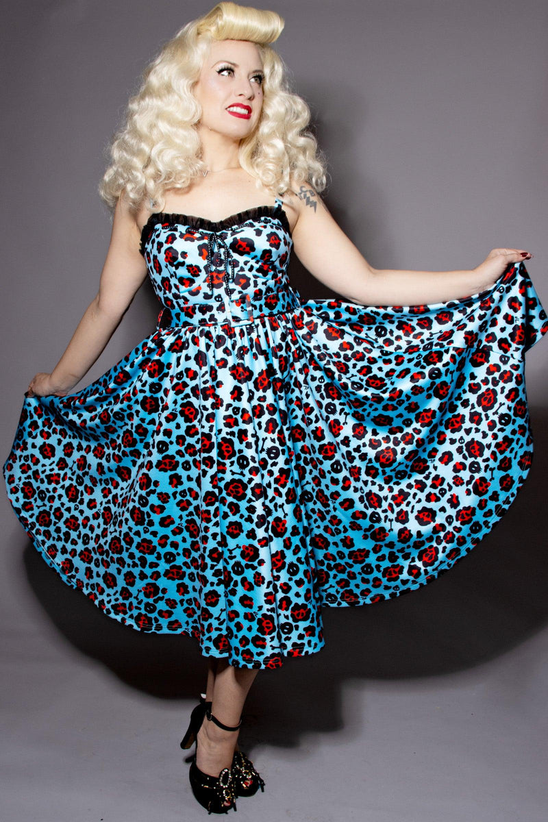 Leopard Print Love Bites Swing Dress from Jessica Louise with playful sweetheart bustline ruffles and ribbon bow accent, featuring enlarged cup sizing, side seam pockets for carrying essentials, ruched back for easy dressing, and adjustable straps for a tailored fit, made from high-stretch fabric to ensure a comfortable yet eye-catching look for fashion-forward women.