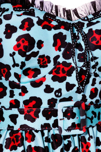 Jessica Louise Love Bites Swing Dress in custom Leopard Print with larger blue leopard spots, boasting a flattering sweetheart neckline adorned with ruffles and a ribbon bow, side seam pockets for convenience, ruched back for effortless wear, adjustable straps for a perfect fit, and high-stretch fabric for comfort, designed to deliver bold, confident style with practical functionality.