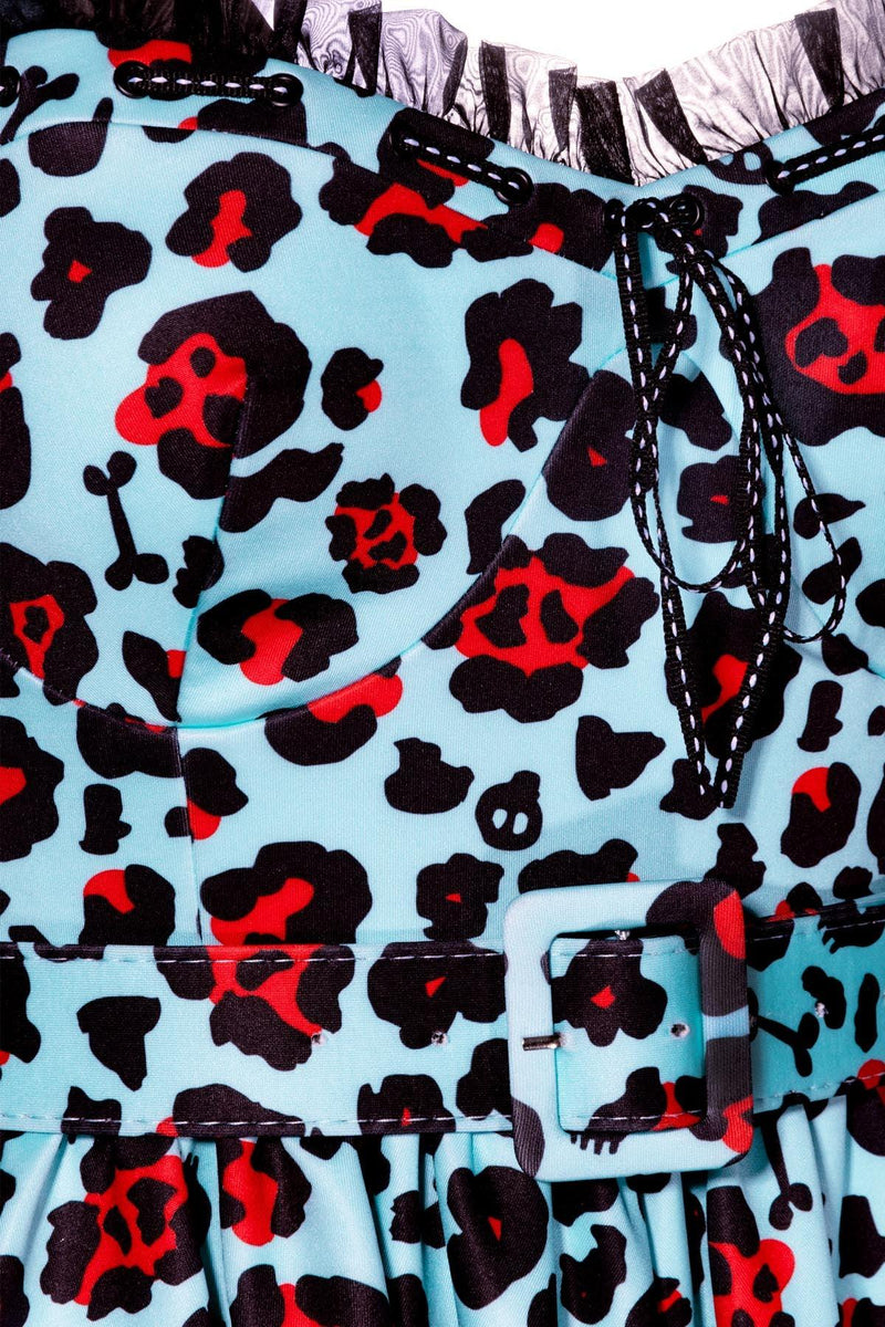 Jessica Louise Love Bites Swing Dress in custom Leopard Print with larger blue leopard spots, boasting a flattering sweetheart neckline adorned with ruffles and a ribbon bow, side seam pockets for convenience, ruched back for effortless wear, adjustable straps for a perfect fit, and high-stretch fabric for comfort, designed to deliver bold, confident style with practical functionality.