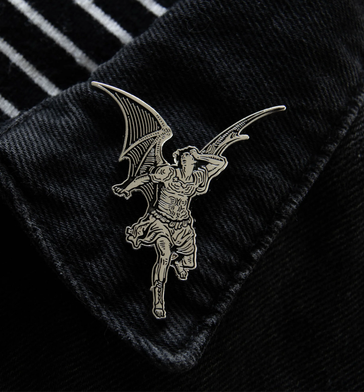 Ectogasm silver metal and black enamel enamel brooch depicting a winged Lucifer inspired by Gustave Doré’s work for "Paradise Lost." At 2.2 x 1.8 inches with sturdy dual clasps, this gothic pin is ideal for black denim jackets, bags, or as part of a curated set of alternative fashion pins.