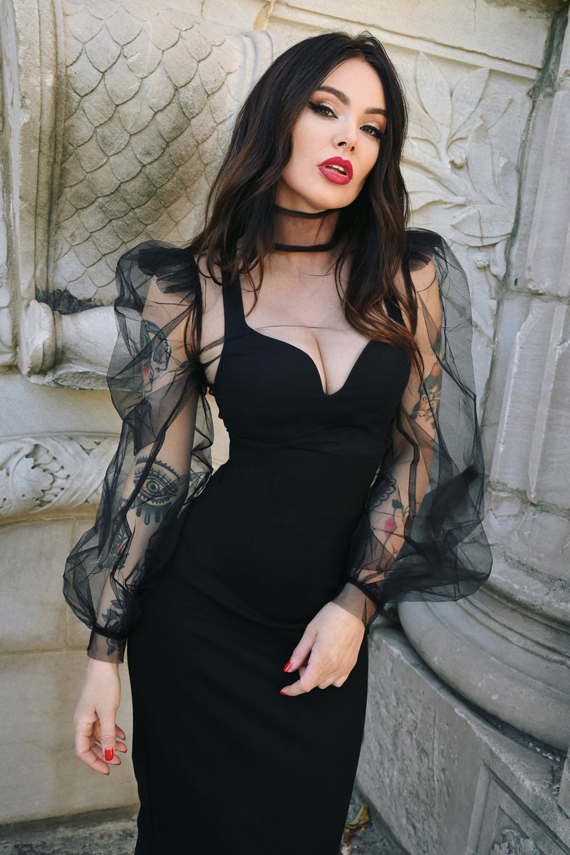 Dramatic sheer blouse made from lightweight stiff chiffon, featuring exaggerated puffy sleeves, high shoulders, and a tall structured collar, finished with a back-button closure for a couture-inspired statement piece suitable for Gothic and alternative wardrobes.