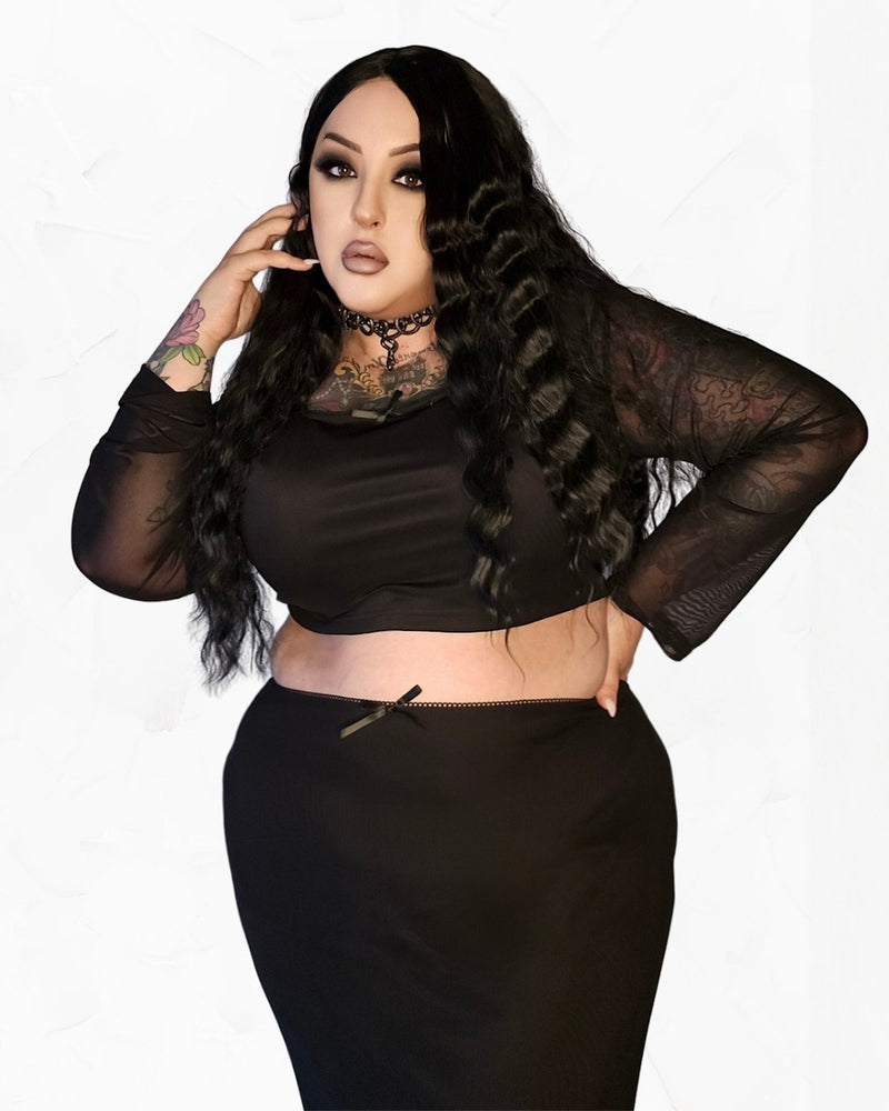 Women’s black mesh two‑piece set featuring a fitted crop top with long sheer sleeves and a square neckline paired with a high‑waisted pencil skirt with a side slit, crafted from soft stretchy polyester‑spandex. Ideal for layering with a leather jacket or styling with statement accessories as part of a coordinated night‑out outfit.