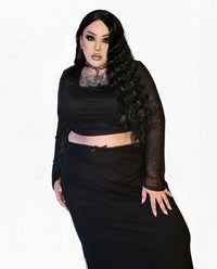 Coordinated mesh ensemble including a sheer long‑sleeved crop top and matching high‑waisted skirt, in a sleek body‑hugging silhouette with delicate bow accents, designed for parties and evening wear. Great as part of a matching set or mixed with textural pieces for a styled look.