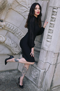 Gothic-inspired black bodycon dress crafted from stretchy bengaline, designed to enhance curves while showcasing a delicate sheer mesh neckline and flowing bishop sleeves, making it an essential piece for dark fashion enthusiasts, formal events, or stylish evening outfits.