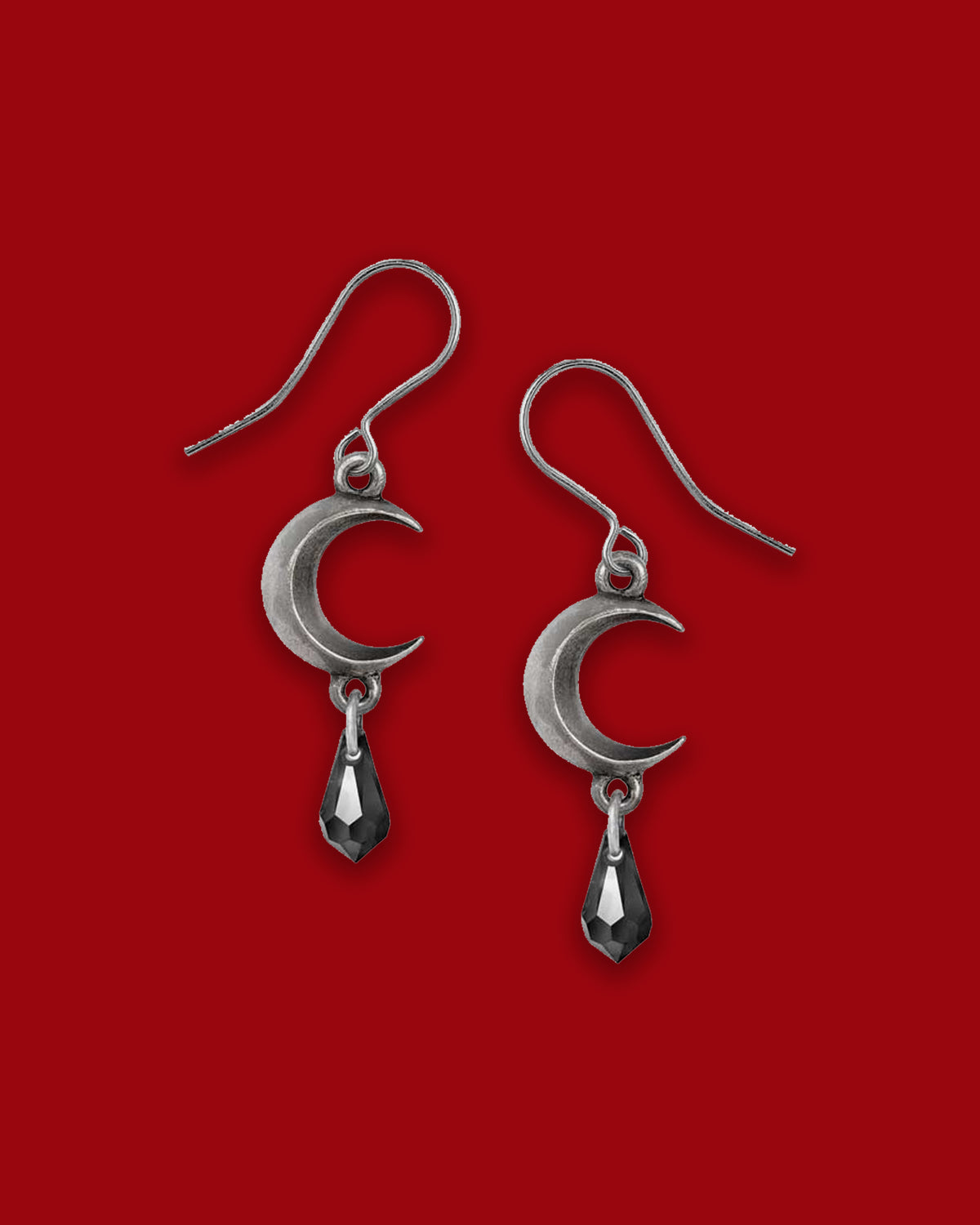 A pair of elegant pewter moon-shaped earrings fashioned with a jet-black Austrian crystal drop, symbolizing tidal magic and lunar mystery, crafted from fine English pewter and surgical-steel ear-wires—lead, cadmium and nickel compliant.