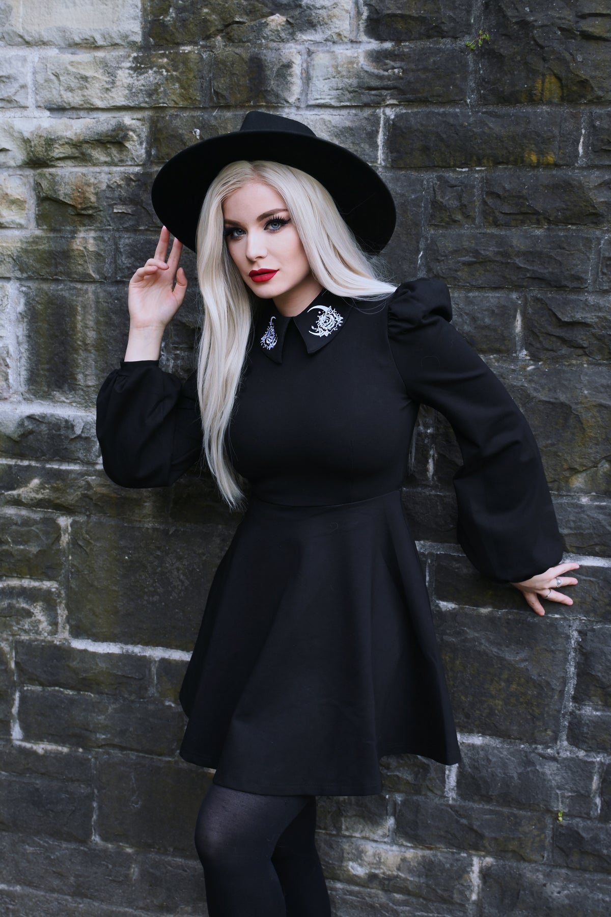 Stylish and unique Moon Flower Dress in black ponte fabric featuring exquisite white embroidery of a moon and flower on its wide collar, enhanced by puffed shoulders and graceful bishop sleeves, merging comfort, elegance, and celestial-inspired details perfect for evening or seasonal wear.