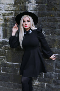 Black Moon Flower Dress crafted for comfort and drama, made with stretchy, thick ponte fabric and highlighted by an embroidered white moon and flower design on the collar, along with puff shoulders and bishop sleeves that evoke a vintage-inspired, celestial aesthetic.