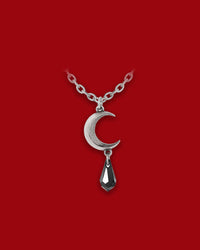 A gothic-chic pendant featuring a finely cast pewter crescent moon paired with a dangling black Austrian crystal teardrop, this necklace evokes the mystique of lunar tides and emotion-laden night. The crescent shape symbolizes intuitive cycles and hidden strength, while the polished pewter and shimmering crystal combine to create a dark elegance designed for both everyday wear and statement styling.