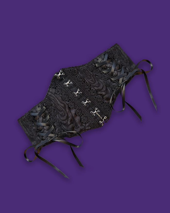 Black stretch waist belt for women featuring elegant lace-up corset front and secure hook-and-eye clasps. Adjustable and comfortable, this one-size-fits-most belt accentuates the waist, perfect for dresses, tunics, or high-waisted outfits. Stylish accessory that adds a flattering hourglass shape.