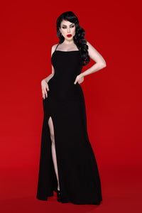 The Onyx Dress is a sleek black maxi dress designed for modern elegance, crafted from thick, very stretchy fabric that contours to every curve while maintaining comfort. Featuring adjustable spaghetti straps for a customized fit and a dramatic high side slit, this pull-on evening dress requires no zipper, offering a smooth, effortless wear that transitions perfectly from dinner dates to formal events.