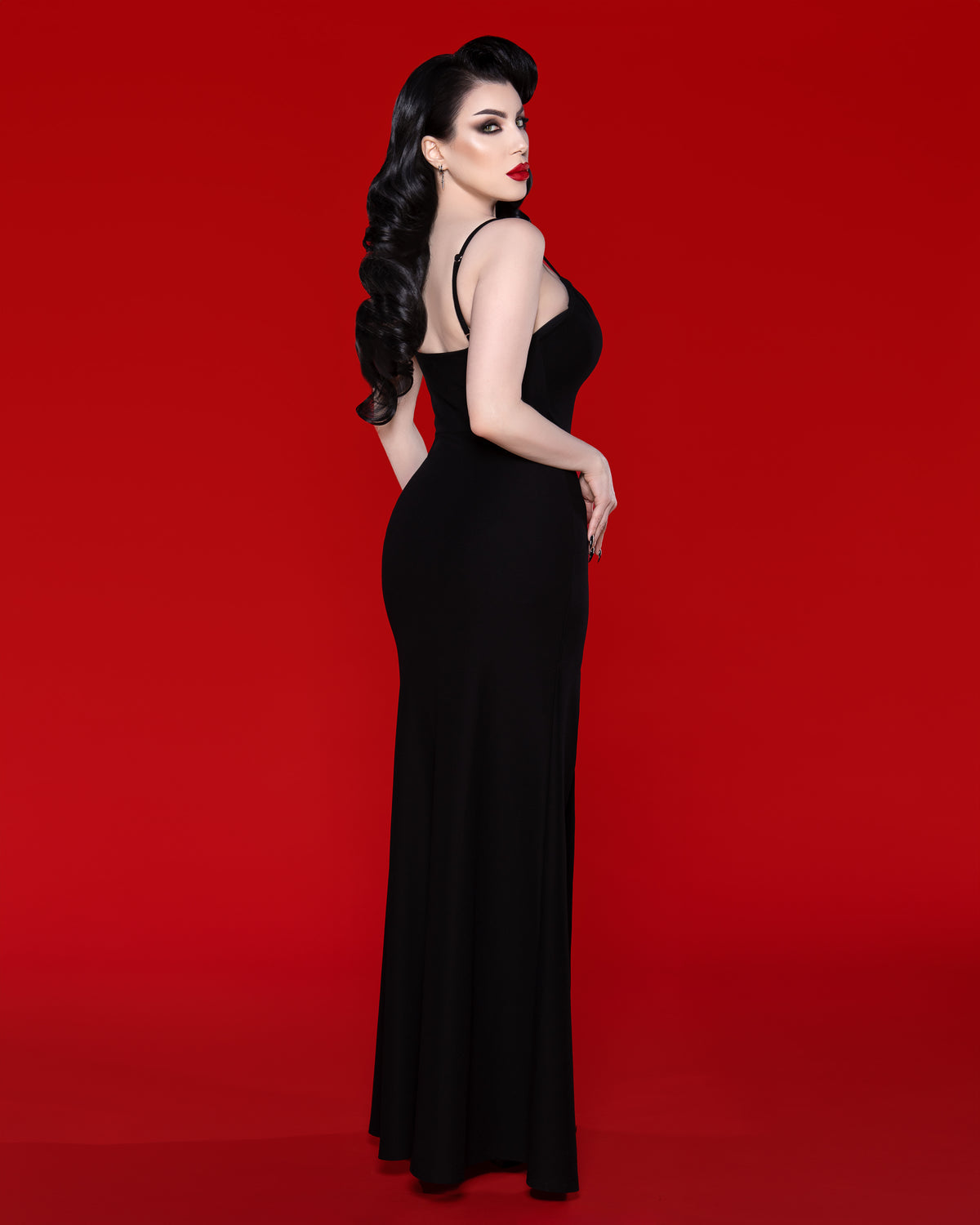 Chic and effortlessly sexy, the Onyx black maxi dress delivers a refined silhouette through its dense stretch fabric that smooths and flatters the figure. With adjustable spaghetti straps for a tailored fit and a high side slit for eye-catching appeal, this pull-on dress offers a modern take on luxury evening wear, perfect for parties, date nights, and sophisticated gatherings.