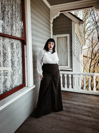 Elegant black Palazzo pants designed with a high-rise waist and flowing wide-leg cut, made from soft crepe fabric with minimal stretch, offering a comfortable yet polished look, and featuring two practical front pockets ideal for carrying small essentials while transitioning seamlessly from office wear to weekend outings.