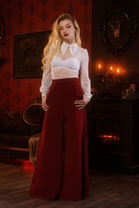 Statement gothic mesh top with long sleeves, dramatic extended collar featuring embroidered crosses, soft stretchy see-through fabric for comfort and movement, a daring back keyhole opening, and versatile color options, perfect for nightlife fashion, festival-inspired outfits, and alternative clothing collections.