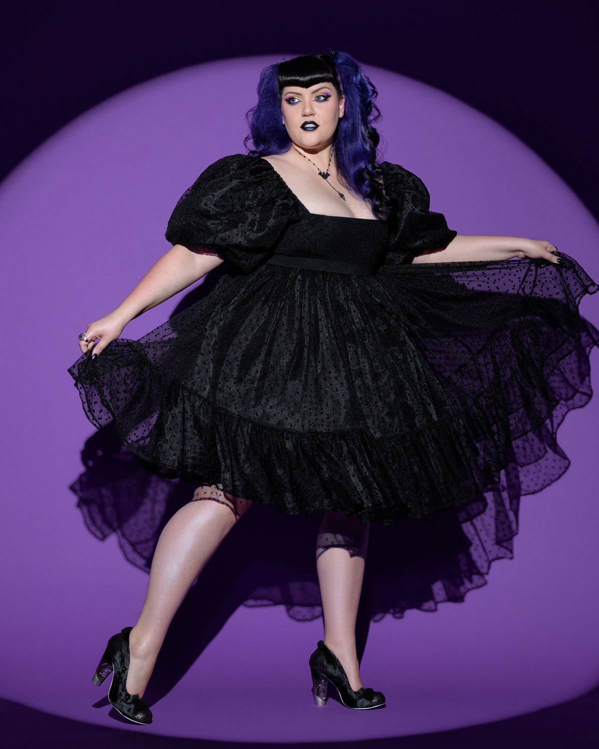 A vintage-inspired black polka-dot chiffon dress with an elegant, square neckline and flattering empire waist. The dress features ¾ puff sleeves that create a romantic, voluminous silhouette, while the full, layered chiffon skirt adds soft movement and fullness to the knee-length hem. Crafted with a fully lined interior and a zip-up back for comfort and structure, this dress blends gothic charm and playful femininity—perfect for spring outings, picnics, or unique gothic fashion looks.