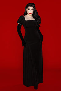 Victorian-inspired Regency dress crafted from luxurious velvet burnout material, designed to contour and flatter the body through a graceful empire waist and form-fitting stretch. Romantic puff sleeves and a scoop neckline enhance femininity, creating an alluring, ethereal appearance. This timeless piece captures a gothic romantic aesthetic while remaining comfortable for modern wear, perfect for evening events, vintage-inspired outfits, or darkly elegant wardrobes.
