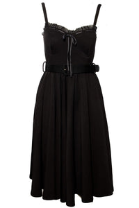 Elegant and playful Love Bites Swing Dress by Jessica Louise, crafted from a high-stretch black poly blend, boasting a sweetheart neckline with delicate ruffles and a ribbon bow accent, designed for comfort with enlarged cup sizing, convenient side pockets, adjustable straps, and ruched back detailing, offering a versatile dress perfect for both casual and statement-making occasions.