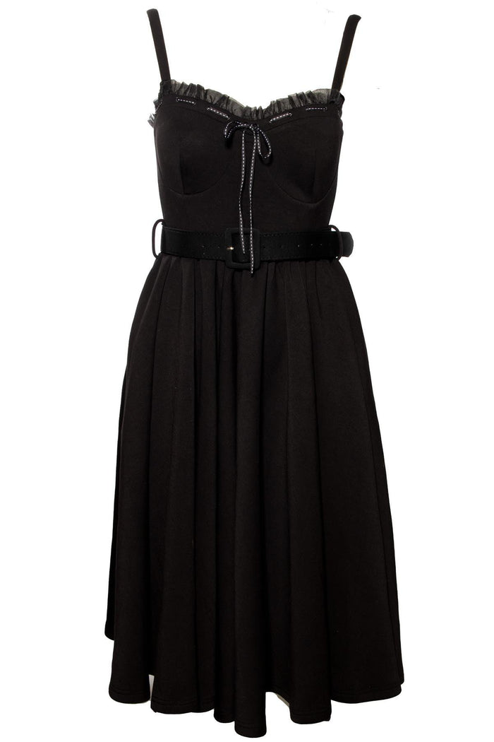 Elegant and playful Love Bites Swing Dress by Jessica Louise, crafted from a high-stretch black poly blend, boasting a sweetheart neckline with delicate ruffles and a ribbon bow accent, designed for comfort with enlarged cup sizing, convenient side pockets, adjustable straps, and ruched back detailing, offering a versatile dress perfect for both casual and statement-making occasions.