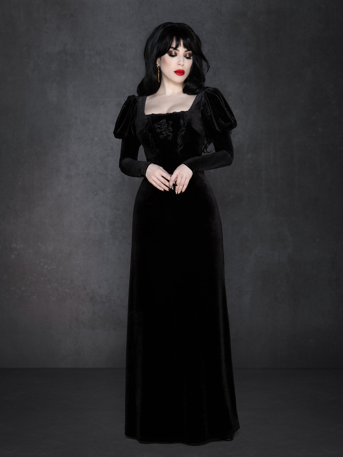 Black velvet gothic gown with floor-length silhouette, puffed Snow White sleeves, and square neckline, featuring detailed wolf embroidery with vine accents on the bust and a flattering structured waist.
