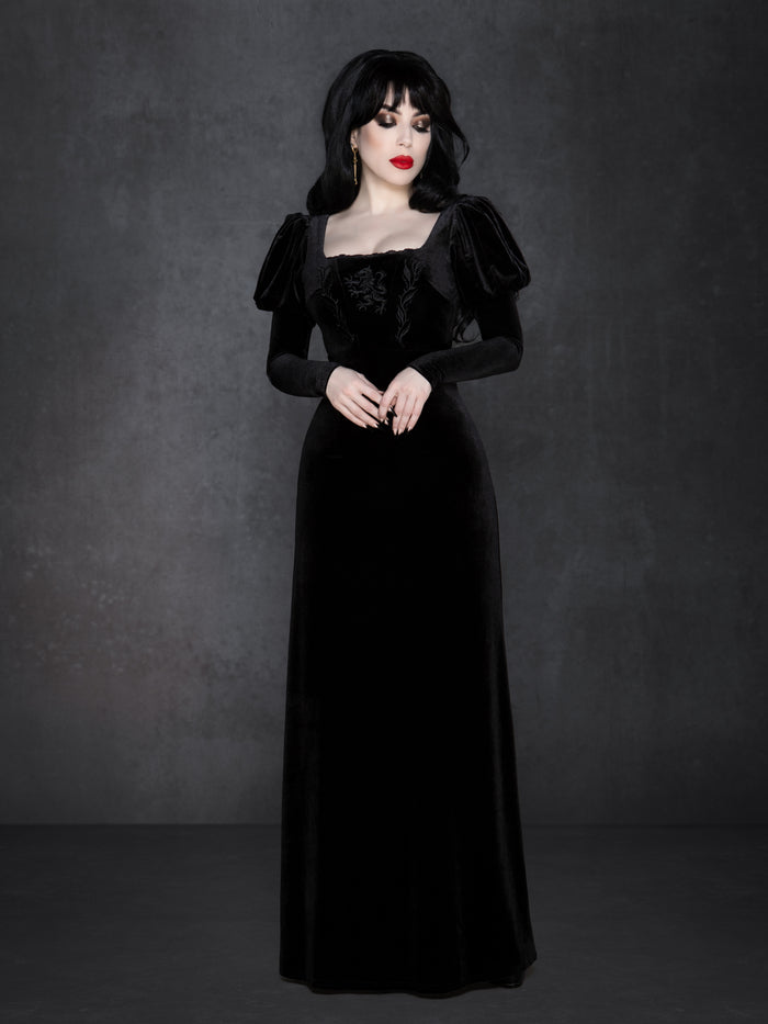 Black velvet gothic gown with floor-length silhouette, puffed Snow White sleeves, and square neckline, featuring detailed wolf embroidery with vine accents on the bust and a flattering structured waist.