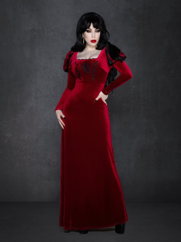 Black velvet gothic gown with floor-length silhouette, puffed Snow White sleeves, and square neckline, featuring detailed wolf embroidery with vine accents on the bust and a flattering structured waist.