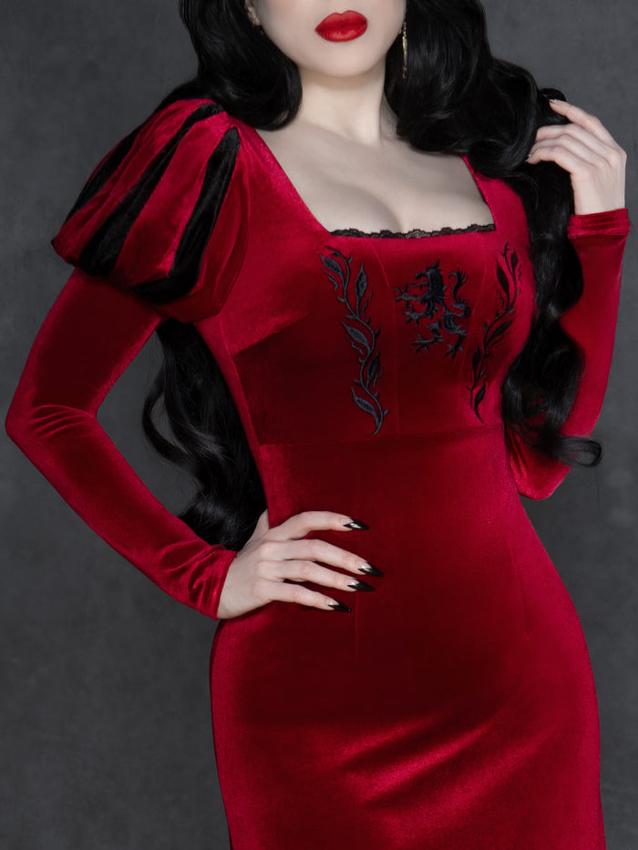 Romantic gothic black velvet dress with dramatic puff sleeves, lace-trimmed square neckline, and intricate wolf and vine embroidery, designed with a fitted waist and elegant full-length silhouette.