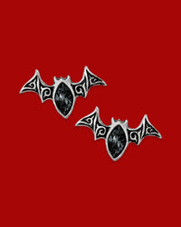 Stylized bat pewter earrings with dark cut crystal details and surgical steel posts. Elegant gothic statement studs, perfect for night-inspired or alternative fashion looks.