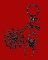 The Black Widow Web Charm Keychain features intricate black metal alloy charms, including a detailed black widow spider, a spooky spiderweb, and a logo charm. Designed to add a gothic touch to everyday essentials, the sturdy metal construction makes this keychain both eye-catching and durable. Its dark, web-inspired design is perfect for attaching to keys, bags, or other accessories.