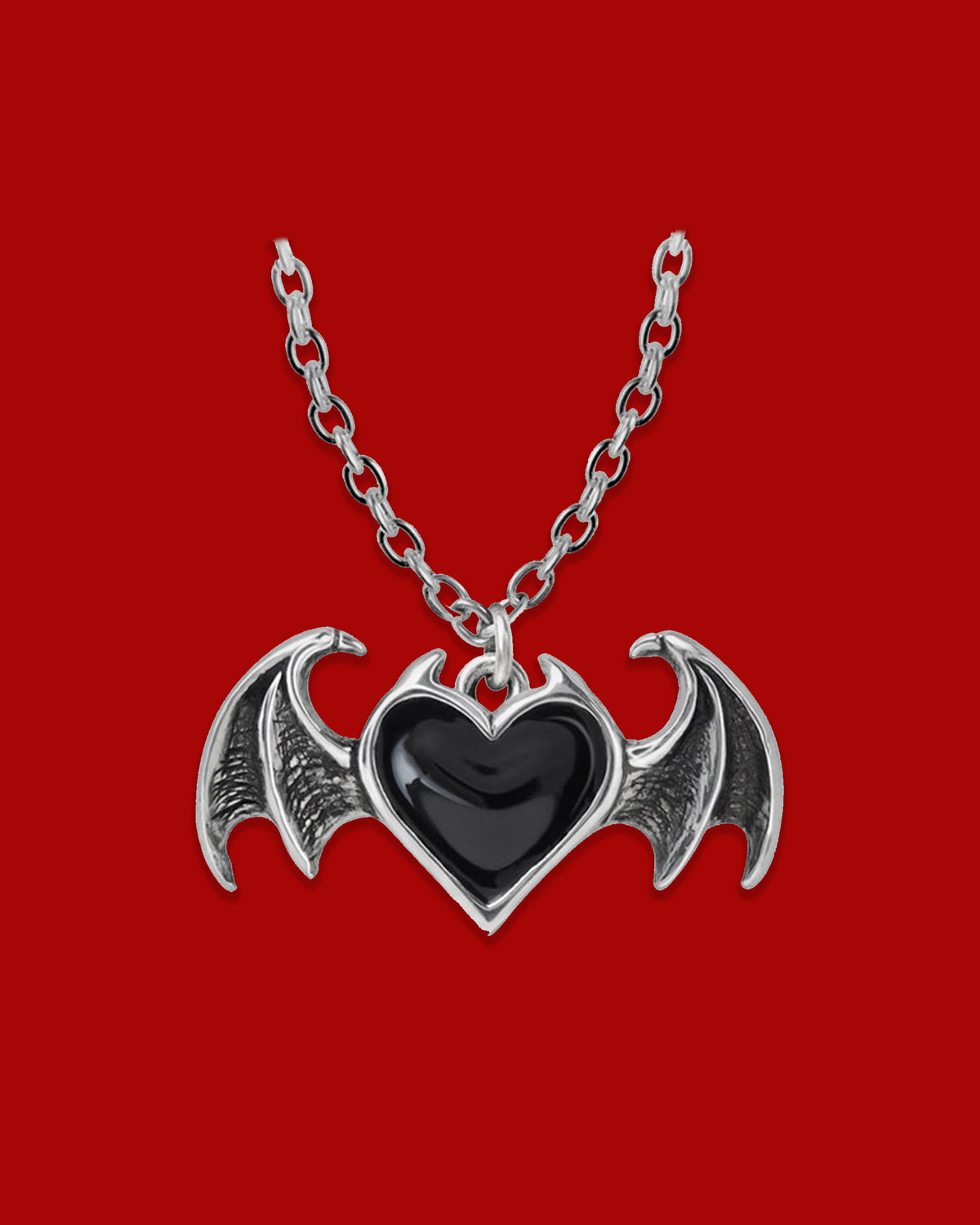Gothic Winged Heart pendant necklace featuring an antiqued pewter heart with black enamel detailing, bat wing accents, and an 18-inch chain with clasp fastening, handmade in England.