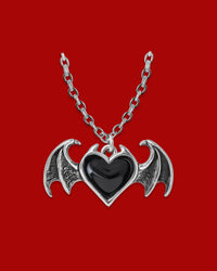 Gothic Winged Heart pendant necklace featuring an antiqued pewter heart with black enamel detailing, bat wing accents, and an 18-inch chain with clasp fastening, handmade in England.