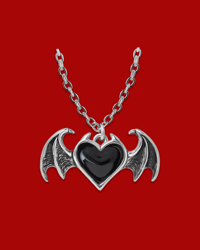 Gothic Winged Heart pendant necklace featuring an antiqued pewter heart with black enamel detailing, bat wing accents, and an 18-inch chain with clasp fastening, handmade in England.