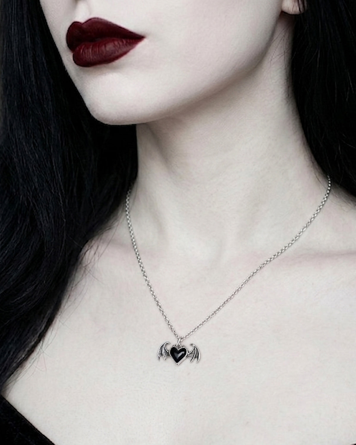 Black enamel and pewter gothic heart necklace with detailed bat wings, antique finish, decorative pendant design, and a silver-tone 18-inch chain created as an alternative fashion accessory.