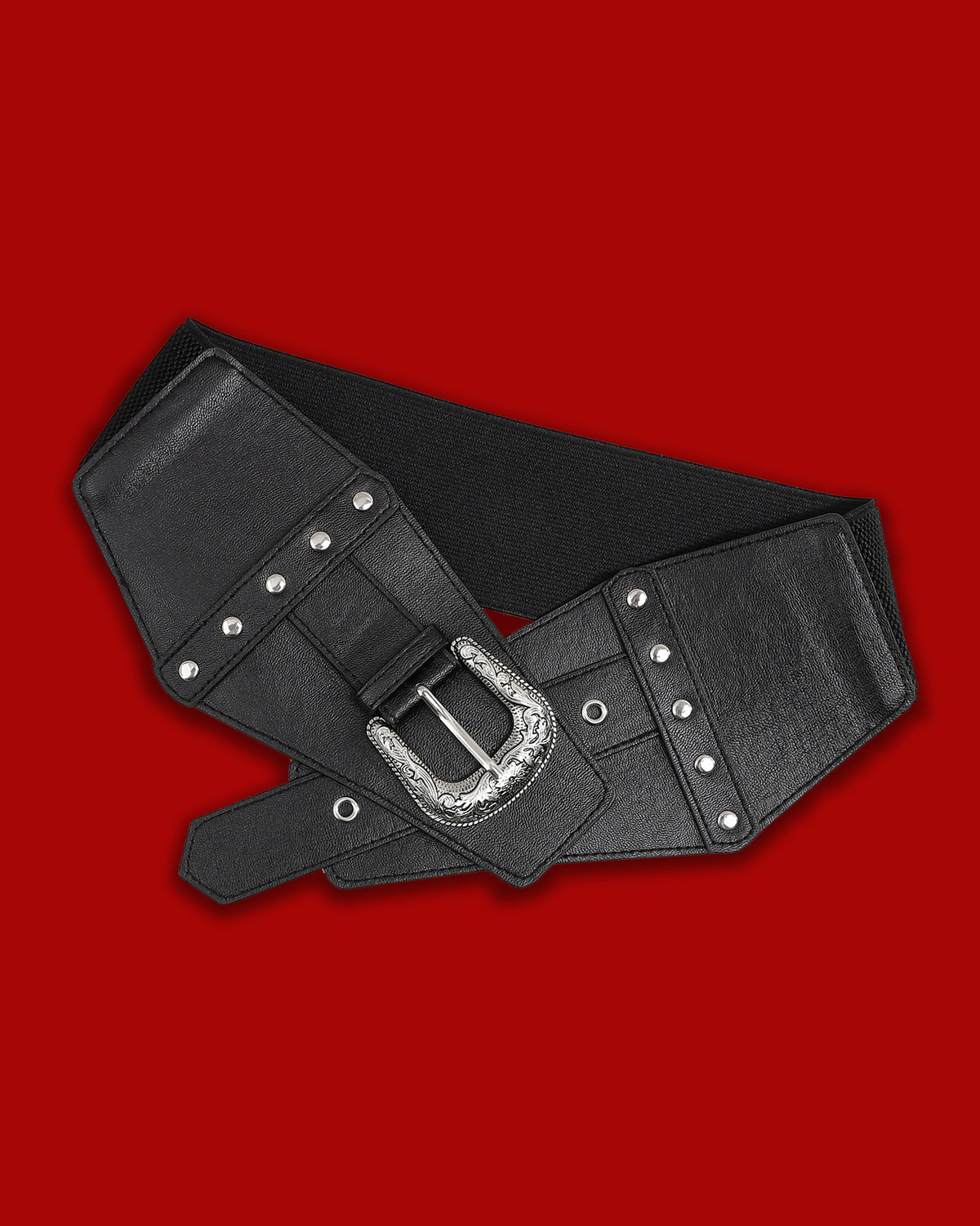 The Dark Rodeo Belt combines western-inspired details with a dramatic gothic aesthetic. A structured synthetic leather front creates a bold overlapping waistline, accented by silver grommets and a large metal buckle with ornate floral engraving. The back features a wide elastic stretch band for a comfortable, adaptable fit, while the functional buckle allows the belt to be adjusted for a secure and flattering silhouette.