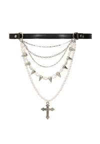 The Divine Edge Belt features a sleek black leather base decorated with rows of delicate pearls, edgy metal spikes, and layered chains. A bold cross pendant adds a distinctive gothic focal point to the center of the belt. Designed to blend softness with punk attitude, this statement accessory brings texture, contrast, and dramatic character to alternative, gothic, and edgy outfits.