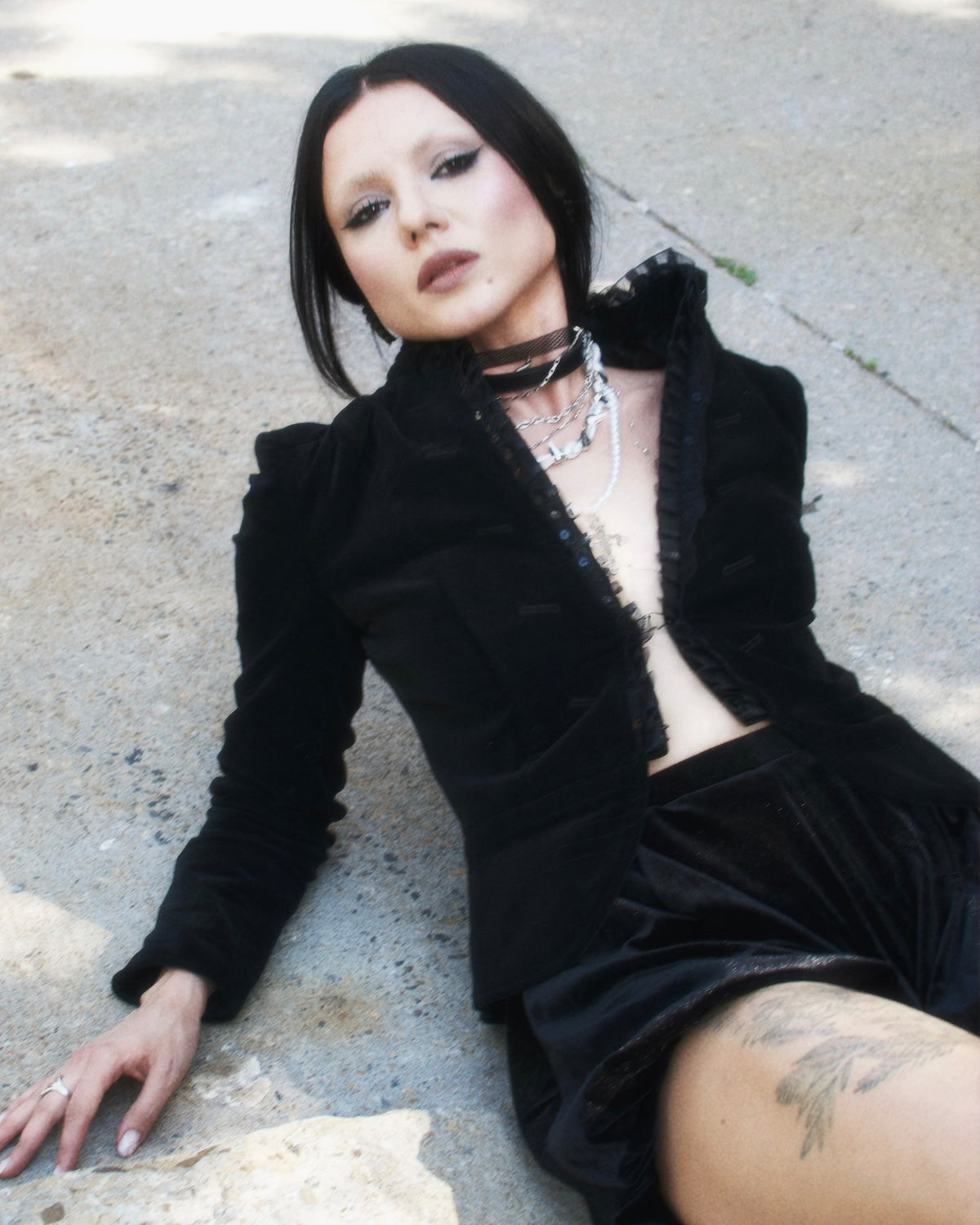 A striking alternative belt combining romantic pearl detailing with punk-inspired spikes, layered chains, and a dramatic cross pendant. Set against a sleek black leather base, the Divine Edge Belt creates a bold contrast between delicate and edgy elements. Its ornate hardware and gothic-inspired details make it an eye-catching accessory for adding attitude and character to dresses, skirts, or casual outfits.