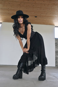 A romantic Renaissance-style chiffon dress with a layered, flowing silhouette and an asymmetrical high-low hem. The off-shoulder neckline and elasticated waist create a comfortable, flattering shape, while convenient pockets add functionality. Inspired by bohemian artists, the irregular hem represents freedom and the breaking of traditional boundaries, giving the dress a whimsical, artistic, and unrestrained character.
