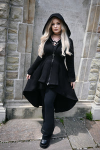 The long high-low hoodie combines cozy construction with dramatic gothic styling. Made from thick 400 GSM 100% cotton, it features a soft fleece lining for warmth, an oversized hood, and deep front pockets. Corset-style back lacing adds texture and shape to the silhouette, while the black front zipper is finished with a gothic cross-shaped pull for a distinctive alternative touch.

