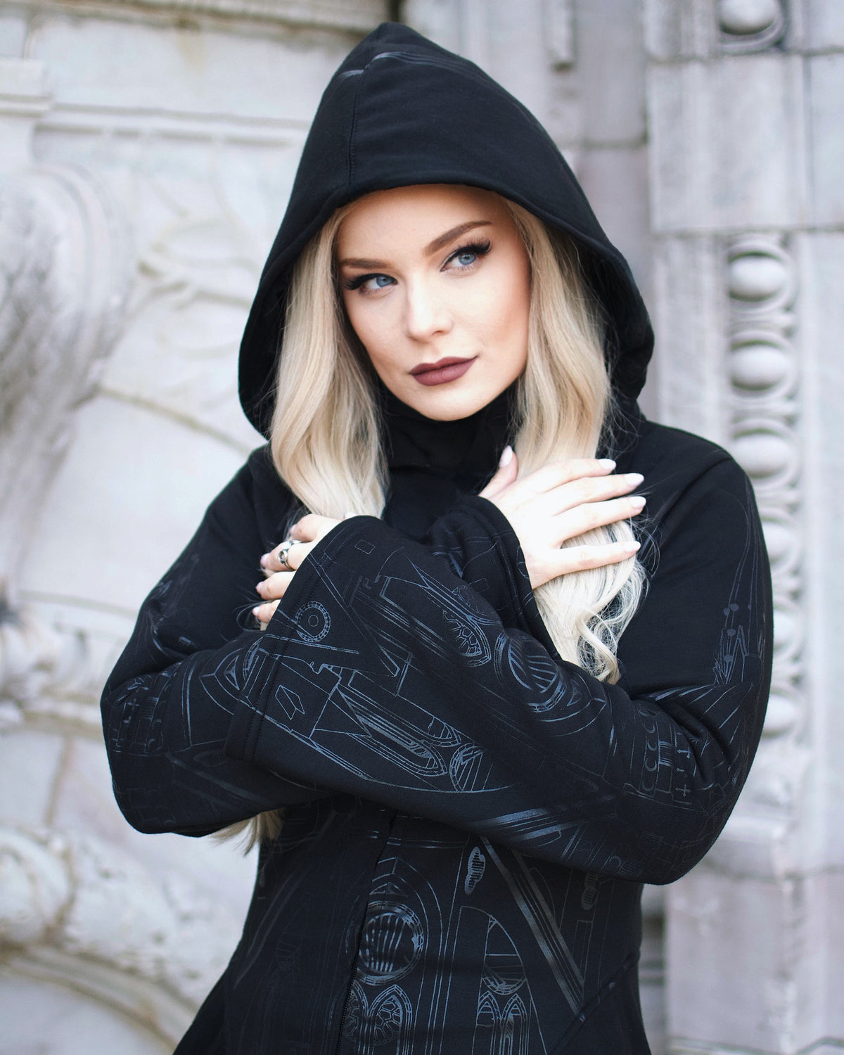 Gothic oversized hoodie from Vixxsin featuring dramatic silver cathedral graphics on front and sleeves, asymmetric hem, corset detailing, and a relaxed fit with deep pockets.