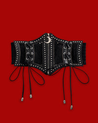The Lunar Corset Belt features a dramatic black corset-style front crafted from synthetic leather with mesh paneling and silver-toned studs. A functional front zipper is finished with a crescent moon charm, adding a dark celestial touch. Decorative side lacing with silver skull aglets enhances the gothic design, while a wide ruffled elastic back provides a comfortable, flexible fit and defined waist.