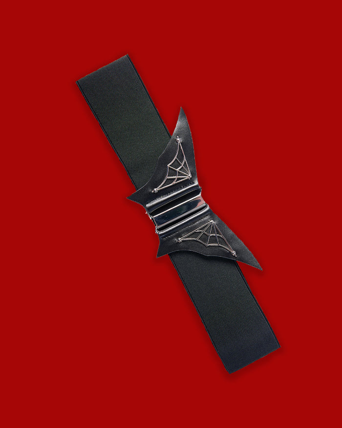 The Night Lovers Belt is a dramatic black waist-cinching accessory designed to add dark glamour to alternative outfits. Combining gothic aesthetics with an easy-to-wear design, this statement belt helps define the waist and create a structured silhouette. Perfect for styling over vampy dresses, oversized tunics, or layered corporate-goth outfits, it adds a bold finishing touch to both dramatic and everyday looks.