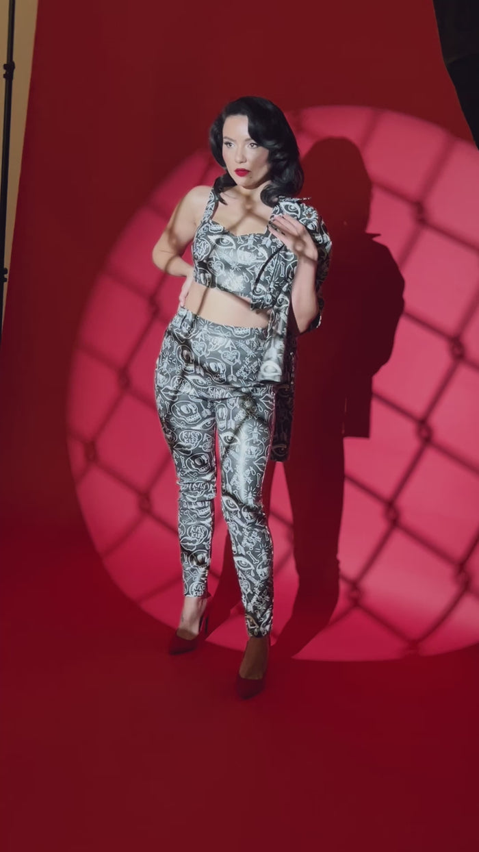 Women's graffiti Moto Jacket designed by Jessica Louise with eye-catching street art, cropped fit, leopard print lining, functional pockets, and an exposed metal zipper with custom skull logo pull, creating a fierce and fashion-forward biker-inspired statement piece.