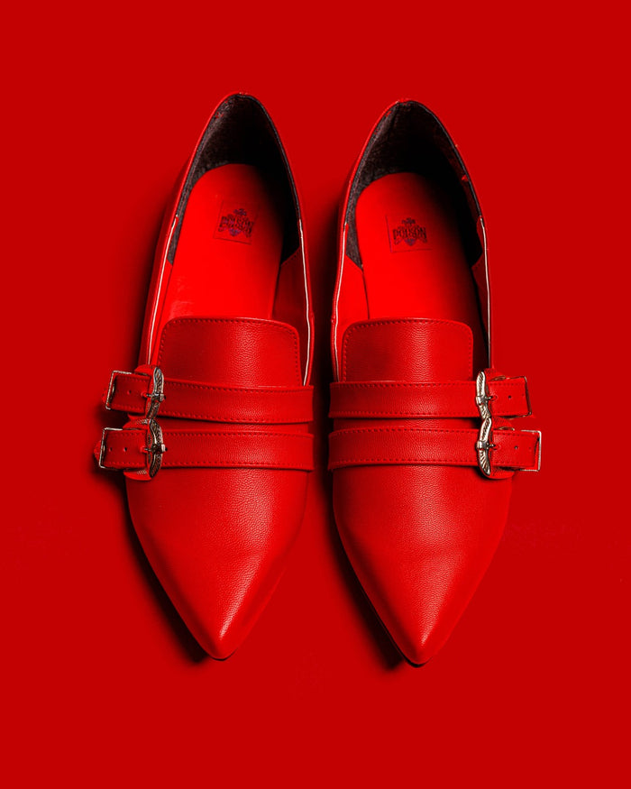 Top view of the Antonella flat shoes in red against a red background.