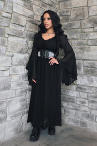 A women's Renaissance-inspired maxi dress featuring a graceful off-shoulder neckline, dramatic bell sleeves, and a comfortable smocked waist. The flowing maxi skirt creates an elegant silhouette and moves beautifully with the wearer. This versatile fantasy dress is ideal for Renaissance fairs, pirate festivals, cosplay, LARP events, garden weddings, music festivals, or styled with a corset belt and boots for a romantic alternative look.