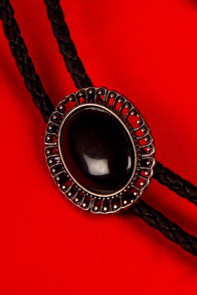 Fuse vintage western flair with gothic edge in this black bolo tie. Sleek, dark, and effortlessly stylish, it’s the perfect finishing piece for gothic wardrobes, steampunk ensembles, or refined evening wear with a shadowy twist.