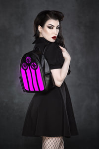 A stylish and alternative LED backpack made from cruelty-free vegan leather, inspired by the beauty of church stained glass windows. Featuring a glowing light-up panel that shifts between red, green, and purple or can be turned off for a monochrome aesthetic, this 23cm x 30cm x 11cm backpack combines gothic charm with practical design. Complete with adjustable straps and inner pocket.