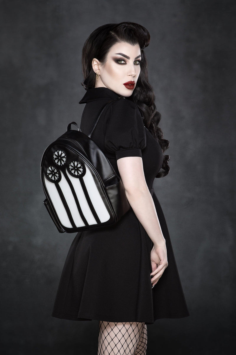 This unique LED chapel backpack crafted from premium vegan leather showcases an intricate stained glass window design that glows in three distinct colors—red, green, and purple. Whether you’re heading to a concert, festival, or just out for the day, this compact 23cm wide, 30cm high, and 11cm deep bag adds gothic elegance to any outfit. With adjustable shoulder straps, a convenient pocket, and a battery-powered light feature, it’s a statement accessory for lovers of dark, artistic, and alternative styles.