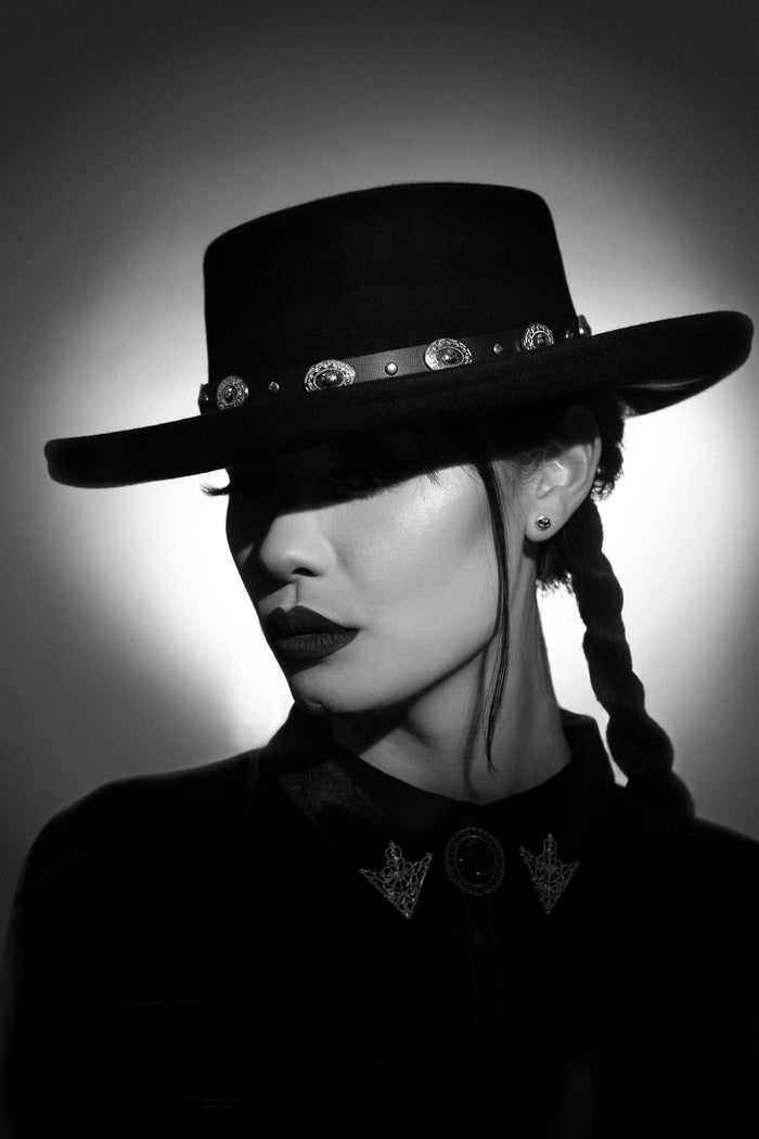 Black vegan leather Western hat belt with silver conchos, designed to slip onto any Katakomb hat. One-size-fits-most, this stylish accessory combines classic cowboy aesthetics with gothic and alternative fashion, elevating your hat collection with a bold, dark Western look.