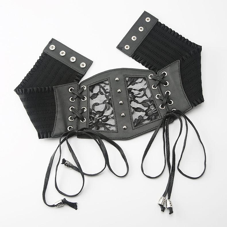 Elegant gothic-inspired lace corset belt styled over a flowing dress, showcasing its mix of soft lace and sturdy vegan leather for an edgy yet romantic fashion statement.