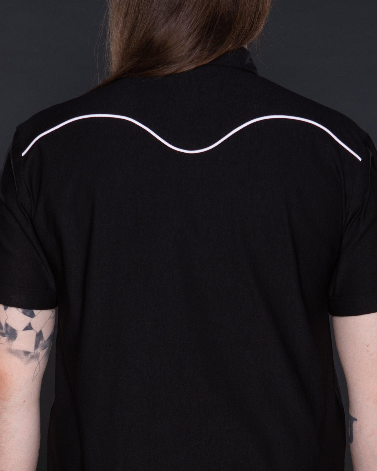 Classic black Johnny Western Shirt in premium soft Bengaline fabric, featuring a tailored fit, crisp collar, and unique western detailing. Accented with eye-catching white snap buttons, delicate minimalist piping, and a subtle rose pattern, this versatile shirt is a timeless addition to any wardrobe, suitable for casual wear, smart-casual ensembles, and layering with jackets or vests.